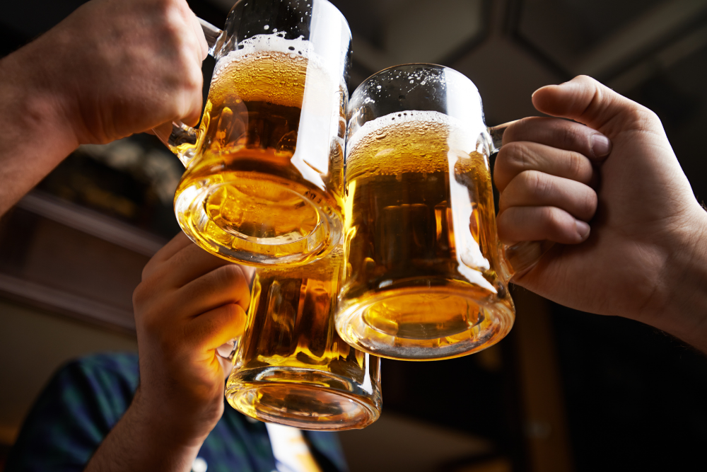 cheers with three mugs of beer
