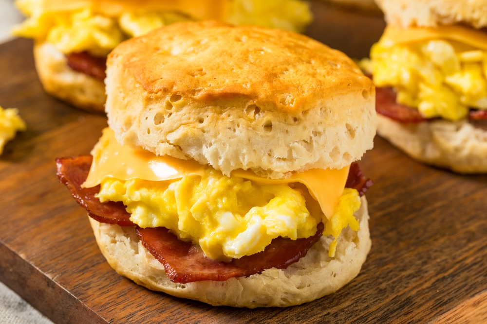 Bacon, egg, and cheese breakfast biscuits on a table