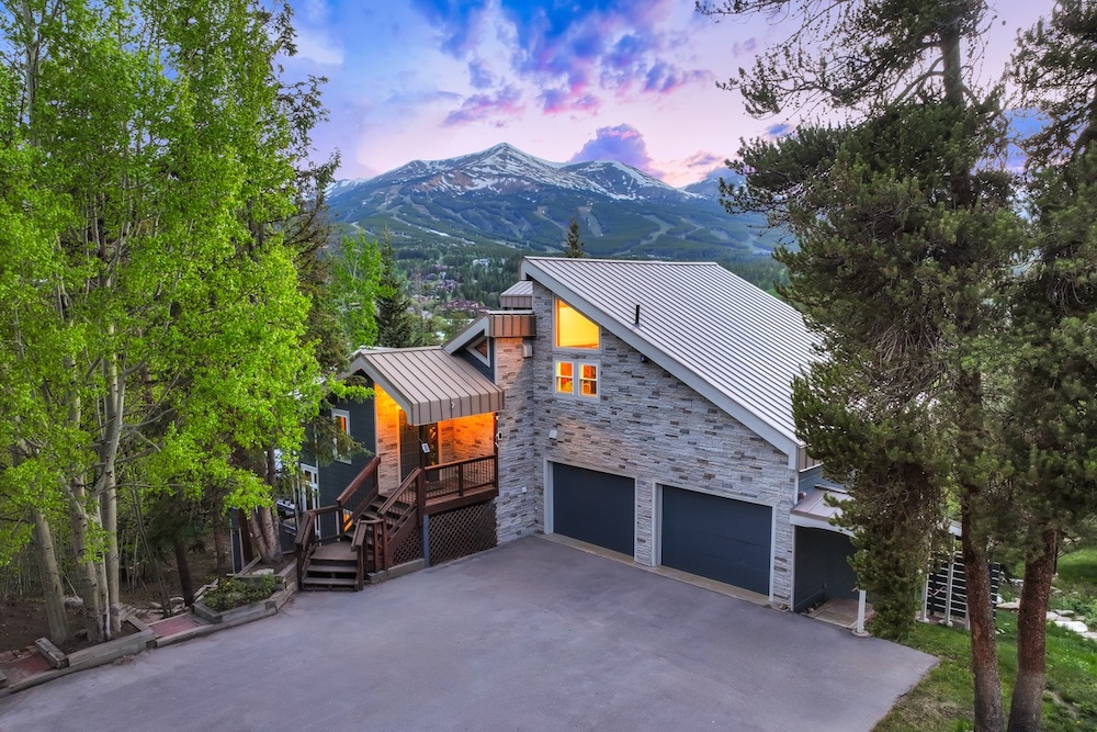 Vacation rental exterior at dusk with mountain view in background